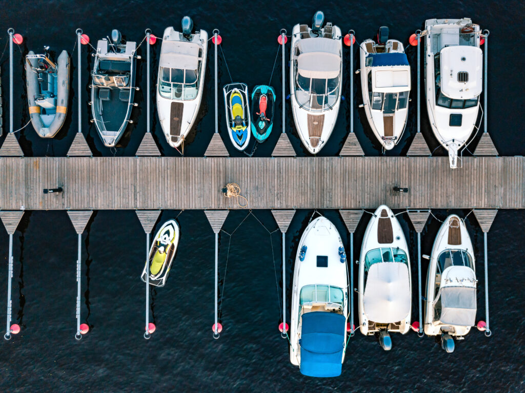 Aerial view of boats jet ski in dock in summer Finland. Colorful