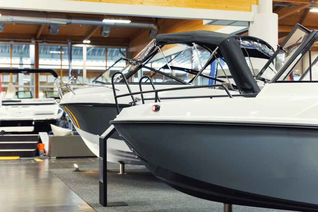 Many small big ship yachts at boat show exhibition indoors hall. Marine fishing yachting sailing vessel expo commercial trading business. Modern recreation sport water transport fair
