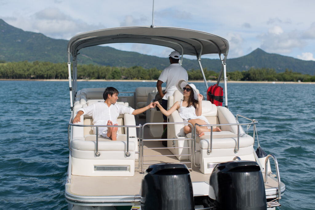 Young couple navigating on a yacht in Indian ocean. Handsome man