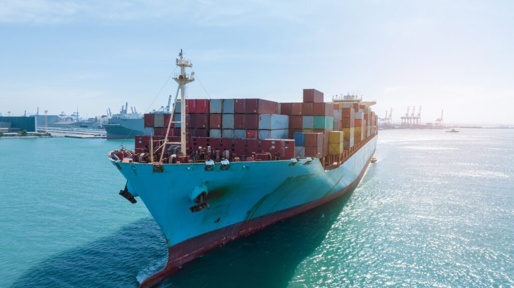front view Cargo Container ship in the ocean ship carrying container and running for import